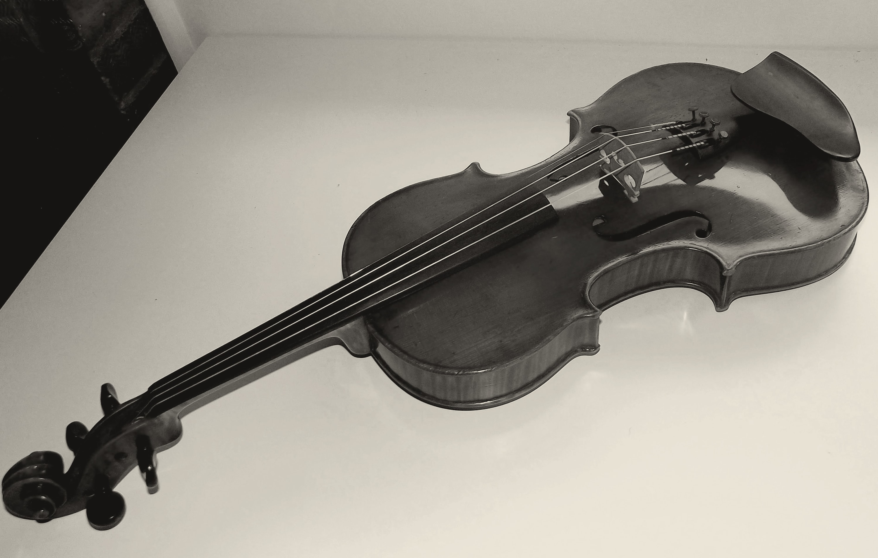 A violin resting on a white table